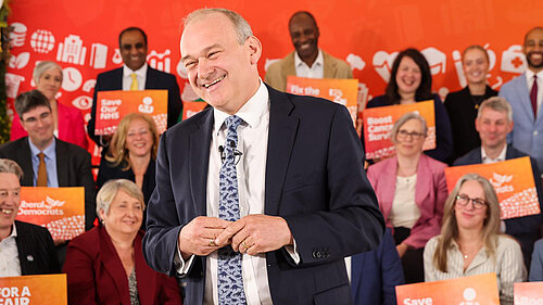 Ed Davey with a child on his shoulders